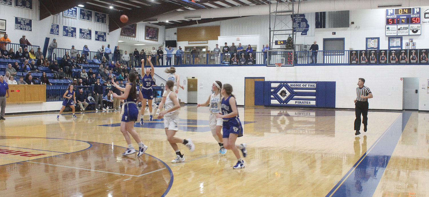 Hartville’s McKinley Sanders, No. 35, launches a shot from just past half-court as time runs off the clock in overtime against Salem in the Norwood Lady Pirate Invitational finals. Her shot fell in at the buzzer, giving the Lady Eagles a 53-51 and first place in the tournament.
